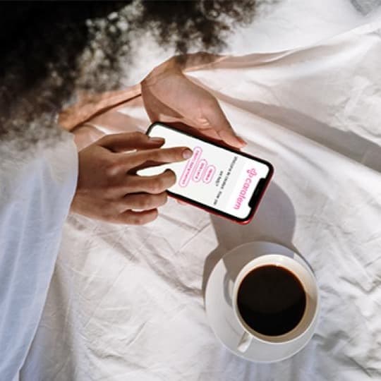 Girl in bed ordering abortion pills on phone Girl in bed ordering abortion pills on phone